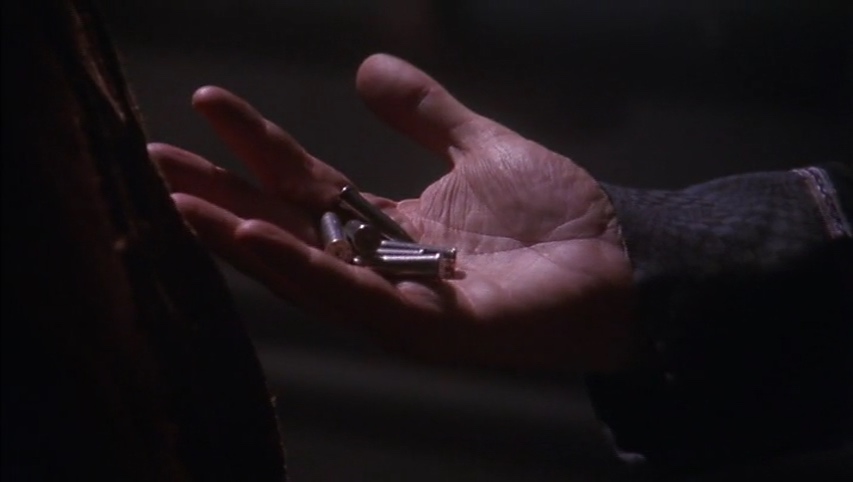 Garibaldi's hand, holding his grandmother's conveniently pocketed antique bullets.